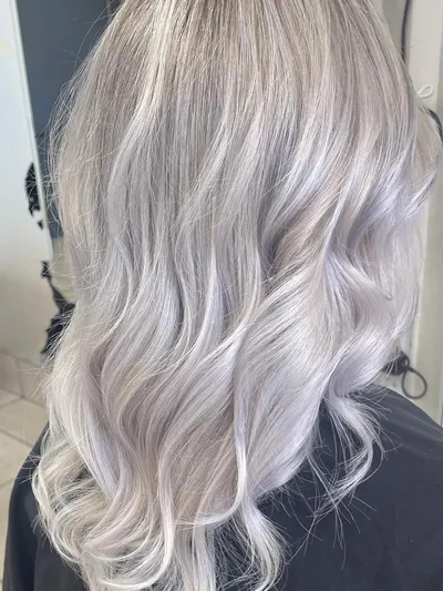 Back view of long wavy hair in icy platinum blonde with cool silve